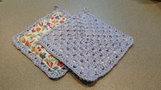 two crocheted placemats sitting on top of a table