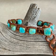 Kingman Turquoise cubes are knotted with Tan Deerskin Leather into a single wrap adjustable bracelet with Kingman Turquoise cube toggle clasp. December Birthstone  Length adjustable 7-10 inches (message me for pricing on bracelets made to fit) 7-7.5 mm Kingman Turquoise cubes  Tan Deerskin Leather Turquoise Boho, Leather Art, Leather Cuffs Bracelet, Deer Skin, Kingman Turquoise, Leather Cuffs, Braided Bracelets, Photo Bracelet, Adjustable Bracelet