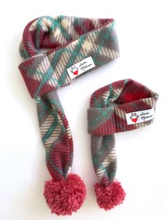 Red and Gray Plaid Dog & Cat Scarf   Love, Matisse fleece scarves for dogs and cats are made from an original scarf design. Each scarf is adorned with a playful yarn pom making this scarf a standout accessory!  Our pet scarves easily slip over your cat or dog's head and can be tightened or loosened by pulling on the pom end.  The scarves are  made from a durable and soft fleece fabric.  Get a matching scarf for yourself! Human scarves have two large pom poms on the ends of the scarf. Sizing  Mea Dog Scarf Pattern, Matisse Dog, Puppy Scarf, Bichon Havanais, Holiday Dog, Cat Scarf, Fleece Scarf, Dog Scarf, Pet Scarf