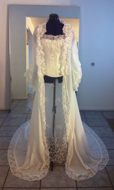 a white wedding dress on display in a room