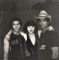 an old black and white photo of three people