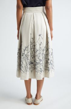 Delicate sketchbook-inspired floral embroidery patterns the hem of this pleated midi skirt tailored from a virgin-wool blend illuminated with a hint of metallic shimmer. Hidden side-zip closure Side-seam pockets 98% virgin wool, 1% polyamide, 1% metallic fibers Dry clean Made in Italy Designer Clothing Elegant Full Skirt With Floral Embroidery, Elegant Cotton Skirt With Embroidery, Elegant Cotton Skirt With Floral Embroidery, Elegant Embroidered Midi Skirt, Elegant Cotton Embroidered Skirt, Fitted Floral Embroidered Midi Skirt, Luxury Floral Embroidered Festive Skirt, Elegant Embroidered Cotton Skirt, Luxury Spring Skirt With Floral Embroidery