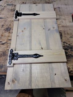 a wooden table with a knife on it and some wood planks around the edge