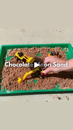 a child is playing with toys in the sand