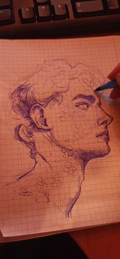 a drawing of a man's head on top of a piece of paper