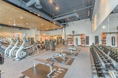 an indoor gym with rows of exercise equipment