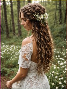 a woman with long hair and flowers in her hair is standing on a path through the woods