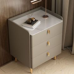 a nightstand with two drawers and a lamp on top