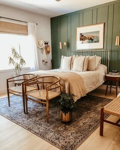 a bedroom with green walls and furniture in it