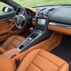 the interior of a sports car with tan leather