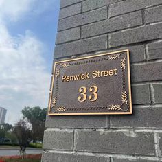 a sign on the side of a brick building that says renwick street 33 in gold lettering