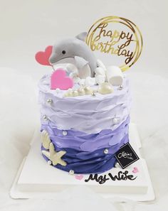 a birthday cake with a dolphin on top