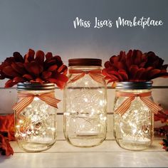 three mason jars with fairy lights in them