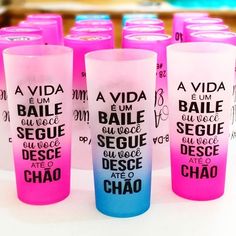 pink and blue shot glasses sitting on top of a white table next to each other