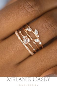 a woman's hand with three different rings on her finger and the words melanie casey fine jewelry