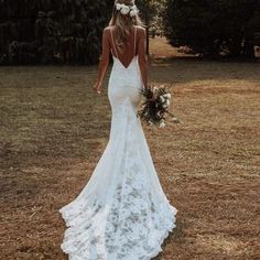 the back of a wedding dress with flowers in it