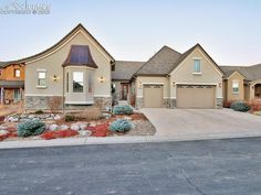 a large home with two garages in front of it