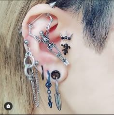 the ear is adorned with different types of piercings