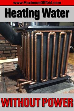 an old heater is sitting on the ground with copper pipes coming out of it