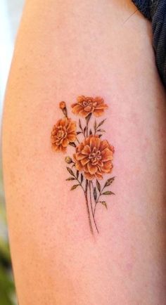 an orange flower tattoo on the right thigh