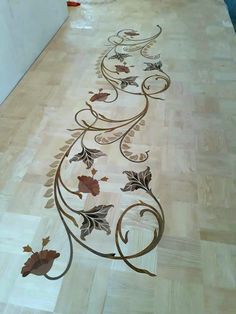 the floor is decorated with leaves and scrolls