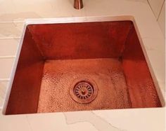 a copper colored sink in a bathroom