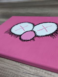 a close up of a pink canvas with an x on it