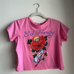 Pink Ed Hardy Crop Top! Super Perfect And Matches With Everything Never Worn Before Retro Letter Print Tops By Urban Outfitters, Urban Outfitters Retro Letter Print Tops, Urban Outfitters Trendy Cotton Tops, Trendy Urban Outfitters Cotton Top, Urban Outfitters Fitted Vintage Top, Vintage Graphic Print Top From Urban Outfitters, Urban Outfitters Vintage Graphic Print Top, Urban Outfitters Graphic Print Summer Top, Vintage Urban Outfitters Graphic Top