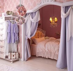 a bedroom with pink walls and purple curtains