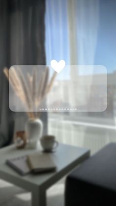 a white vase sitting on top of a table next to a window filled with curtains