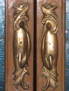 two metal doors with ornate designs on them