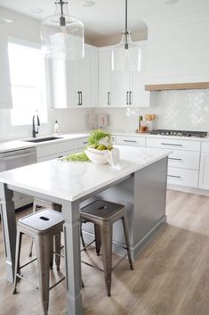 a kitchen island with two stools in front of it