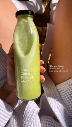 a woman is holding a green smoothie in her left hand and the words celery lemon pineapple aloe vera on it