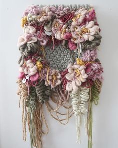 a piece of art made out of yarn and flowers