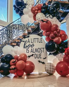 balloons are arranged around a sign that says, a little boo is almost duee