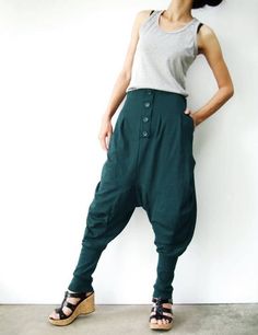 "* ALL ORDERS ARE SHIPPED VIA DHL EXPEDITED MAIL * Cotton jersey harem pants feature a drop crotch design with tapered pant legs, pleated front detail, side seam pockets, elastic back waistband, ribbed cuffs and four tucks at inseam create volume through leg. Roll up the ribbed cuffs hem for an utlra relaxed look! * Pull-on style * decorative pleats front and buttons detailed * Elastic back waistband provides a personal fit * Four tucks at inseam * Side seam pockets * Wide ribbed cuffs Measureme Baggy Full-length Pants With Button Closure, Baggy Pants With Button Closure, Green High-waisted Pants With Button Closure, Green Cotton Pants With Buttons, Green Bottoms With Buttons For Fall, Green Baggy Bottoms For Fall, Green Bottoms With Button Closure, Green High-waisted Pants With Buttons, Green Trousers With Buttons