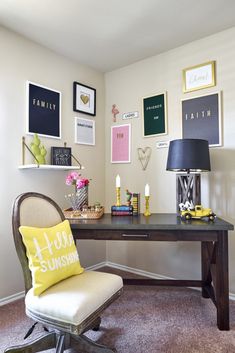 a desk with a chair, lamp and pictures on the wall