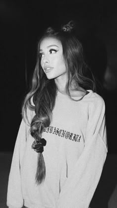 a woman with long hair wearing a sweatshirt