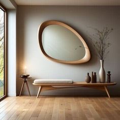 there is a large mirror on the wall in this room with wood flooring and furniture