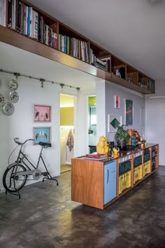 a bike is parked in front of a bookshelf