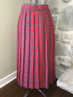 80's Women's pleated plaid skirt. Longer style and hits below the knee. Zipper closure with top button to secure.  Skirt Measurements (Approximate): Waist: 30 inches Length: 31.5 inches Classic Pleated Plaid Skirt, Fitted Pleated Plaid Skirt, Scottish Style Fitted Plaid Pleated Skirt, Scottish Plaid Pleated Bottoms, Pleated Plaid Skirt, Skirt Measurements, Womens Skirts, Plaid Skirt, Long Style