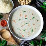 the soup is prepared and ready to be eaten with other ingredients on the table nearby