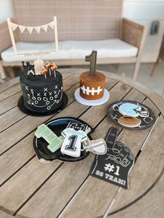 a table topped with cakes and decorations on top of a wooden table