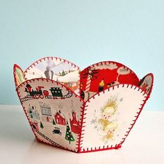 an open heart shaped box with pictures inside