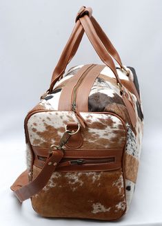 Discover the perfect blend of sophistication and elegance with our luxurious cowhide duffle bags, crafted from the finest materials. Free shipping on all our cowhide bags and purses. Dimensions 20" long x 12" high x 11" wide (approx) Detachable Shoulder Strap approx 40" long. Handle drop (from the middle) = 8" (Perfect to hold it or carry on shoulders) All duffels are lined and have zipper pockets inside. * High Quality Cow Hide Leather * Double Stitched Seams * Thick Stitching * Reinforced Hand Thick Stitching, Cowhide Bag, Bags And Purses, Gym Gear, Duffle Bags, Cow Hide, Cowhide Leather, Travel Bag, Inside Pocket