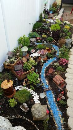 a small garden with rocks and plants on the ground