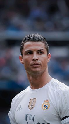 a soccer player is looking at the camera with an intense look on his face and shoulders