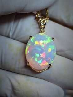 Big pink  white opal  17x20mm   14.67ct. Pretty and bright lovely floral pattern of 3D color in a pink, purple cloud of stone, mounted on a very simple low profile 14k solid gold pendant setting with a nice simple shiny bail. I can mount it on a smaller pendant if you wish, where there is no mount visible top and bottom. White Oval Opal Necklace, White Ethiopian Opal Gemstone Jewelry, White Ethiopian Opal Cabochon Jewelry, White Ethiopian Opal Gemstone Necklace, Handmade White Ethiopian Opal Jewelry, White Opal Cabochon Necklaces, White Opal Pendant Jewelry, White Opal Gemstone Necklace, White Opal Cabochon Necklace