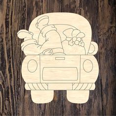 a wooden cutout of a car with flowers in the trunk and a man driving it