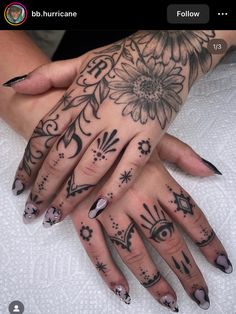 a woman's hand with tattoos on it